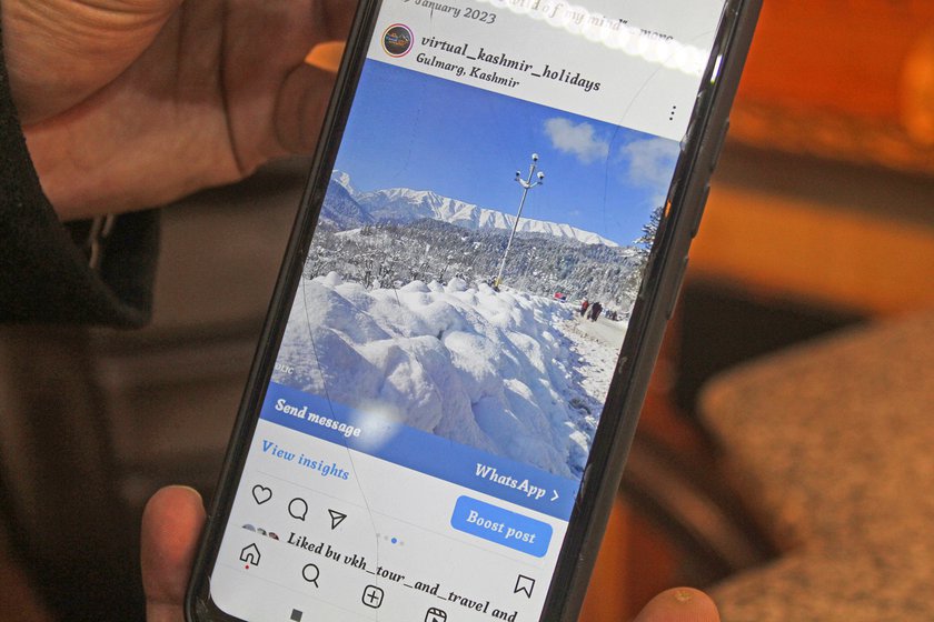 Right: Mudasir Ahmad shows a photo of snow-clad mountains in January 2023
