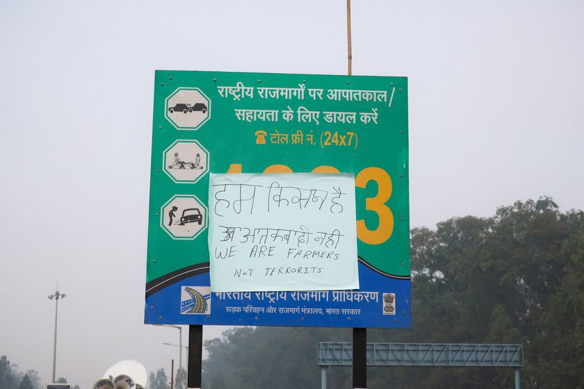 Right: A poster put up by the protesting farmers says – 'We are farmers, not terrorists'