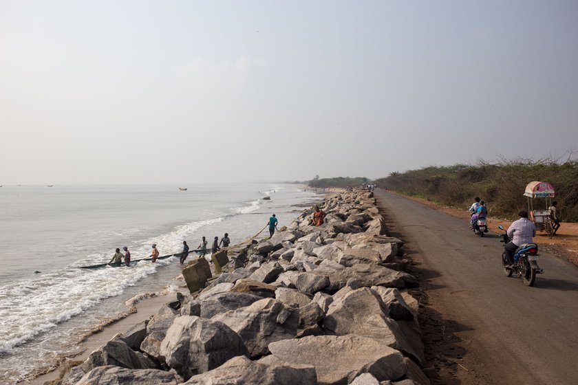 Off the Uppada-Kakinada road, fishermen pulling nets out of the sea in December 2021. The large stones laid along the shore were meant to protect the land from the encroaching sea
