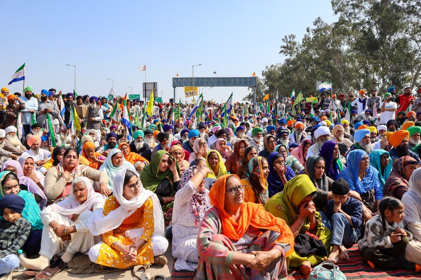 Right: Women sit near the stage put up at Shambhu border