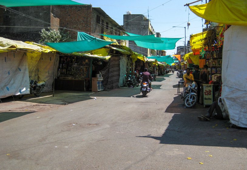 The chappal stand and cloak room opposite the temple are empty (left), the weekly market is silent (middle) and the narrow lanes leading to the temple are all deserted

