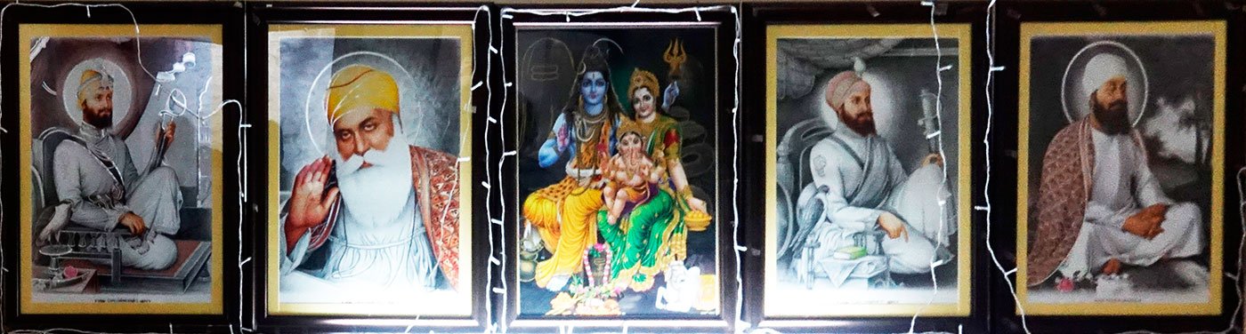 The first two are of Guru Gobind Singh and Guru Nanak. The last two are of Guru Hargobind and Guru Tegh Bahadur. The central one in this line up of five is of Shiva and Parvati with a baby Ganesha.