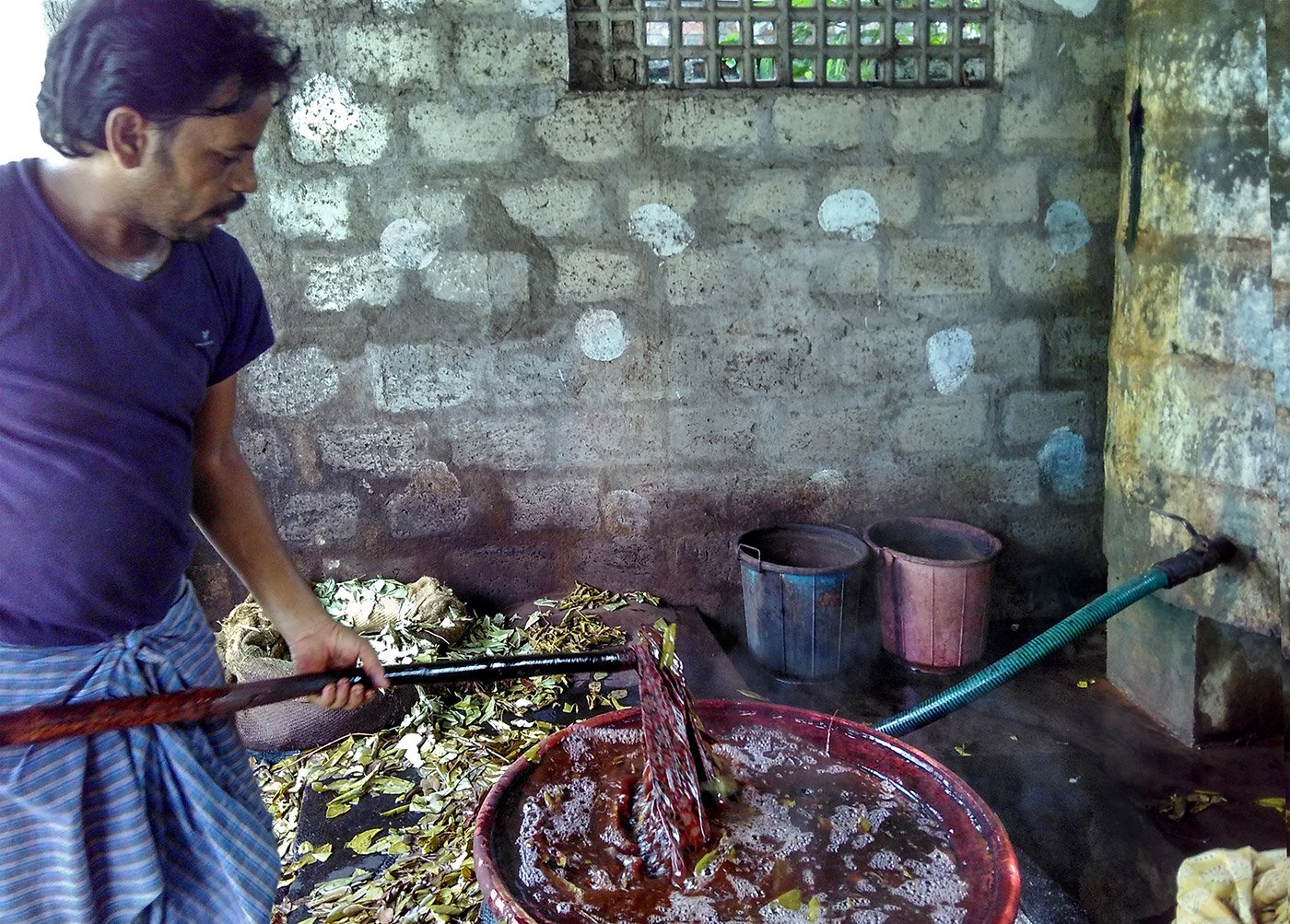 The fabric is put into boiling water with raw leaves to give the Kalamkari prints better colour and texture 