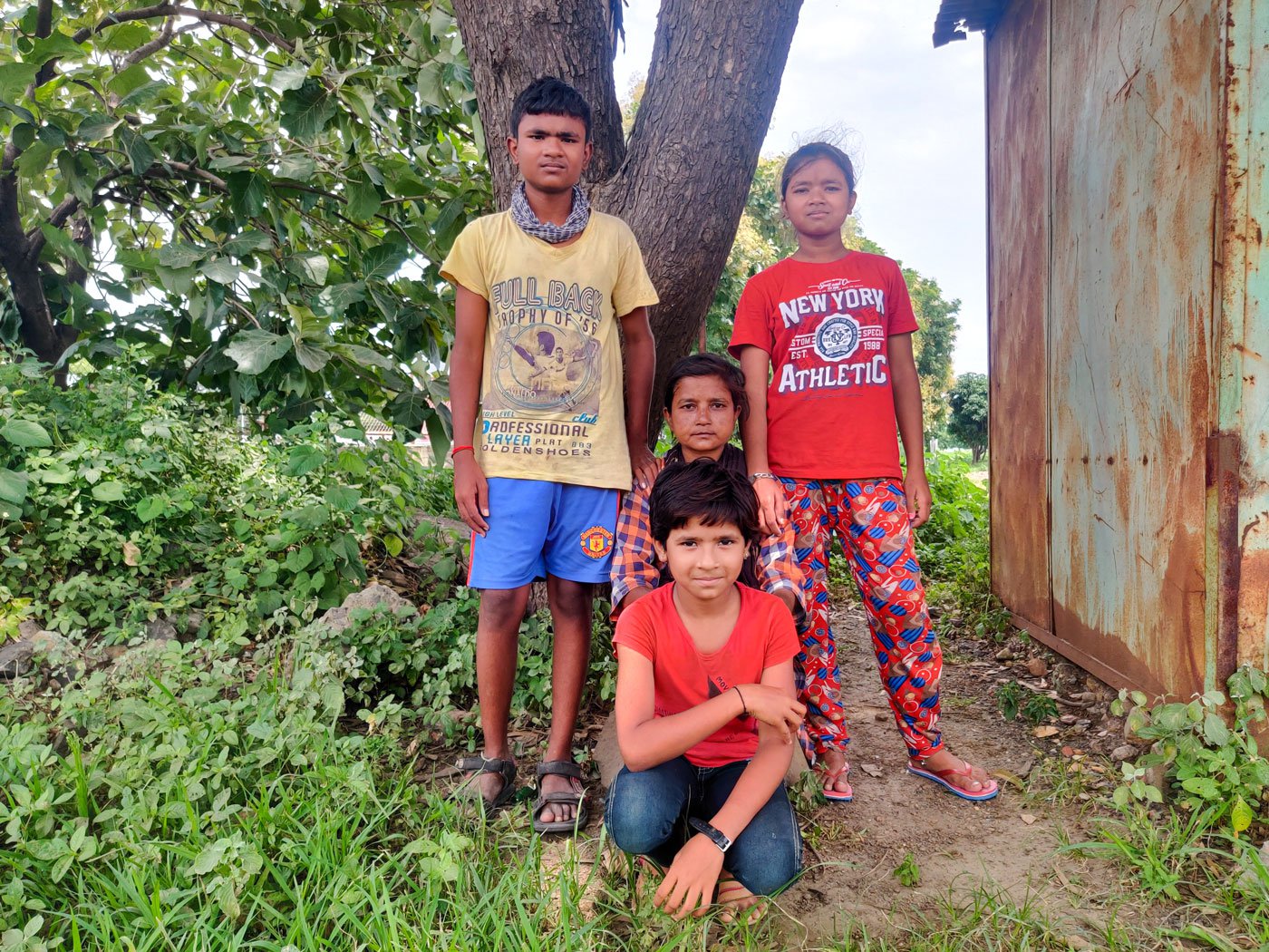 Mangal with three of her four children: the eldest, Sagar (left), Sanjana and Sapna (front). Loss of work has put the family under strain