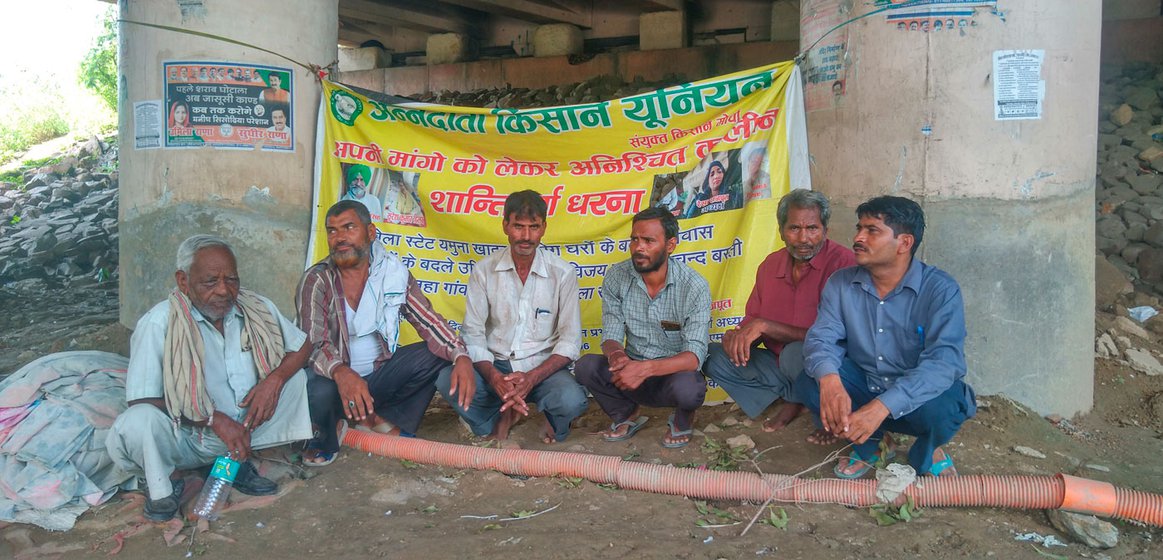 Several families in Bela Estate, including Hiralal and Kamal Lal (third from right), have been protesting since April 2022 against their eviction from the land they cultivated and which local authorities are eyeing for a biodiversity park.