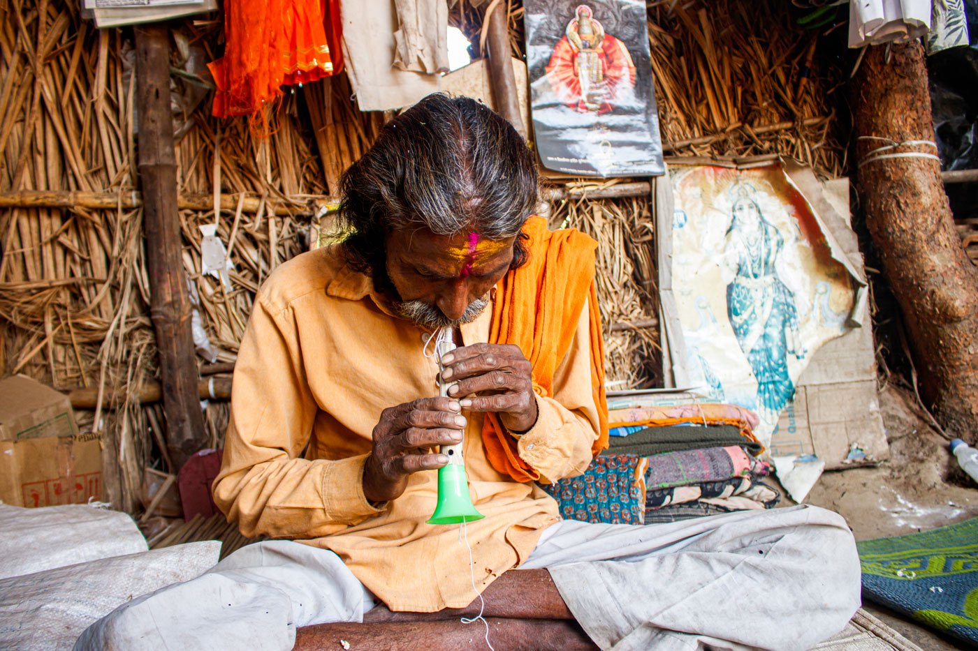 Narayan inspecting whether the jibhali ( reed) he crafted produces the right tones