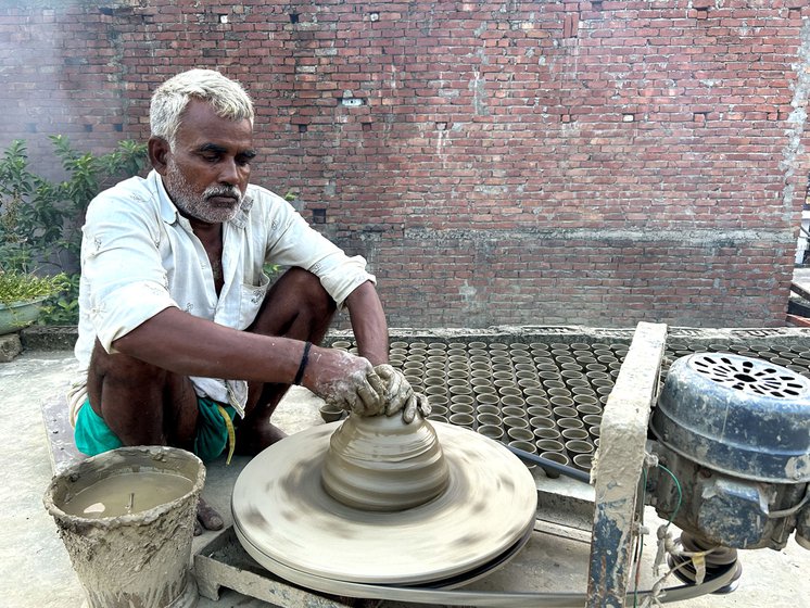 Deshraj making pots on his terrace