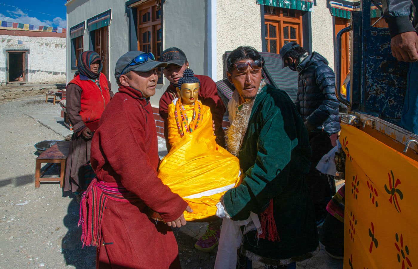 Sonam Dorje (left) and his fellow villagers carry the Buddha idol from the Mene Khang monastery of Khuldo for the festival
