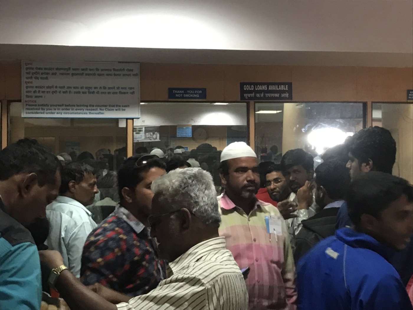 Frustrated members of the public throng the inside of the Shahganj branch of the State Bank of Hyderabad. Outside, the queue is nearly a kilometre long