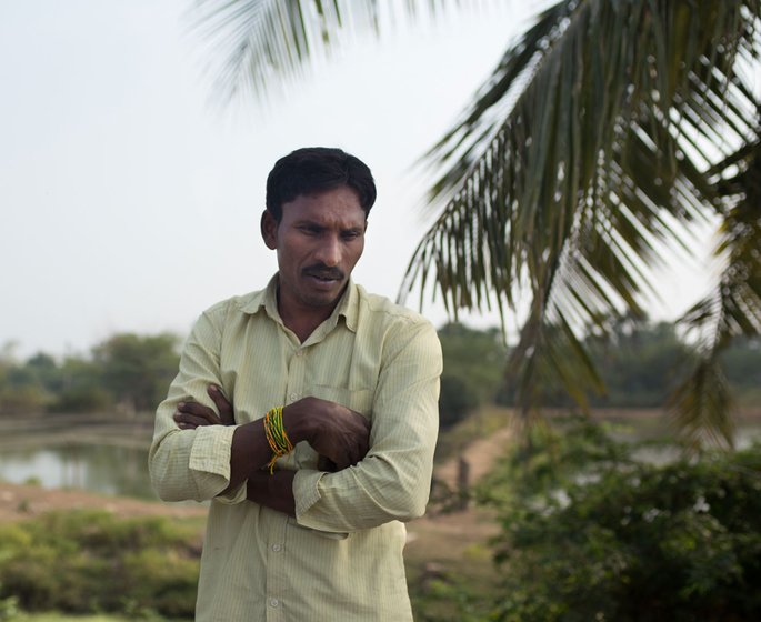 Portrait of a man outdoors with his hands folded across his chest