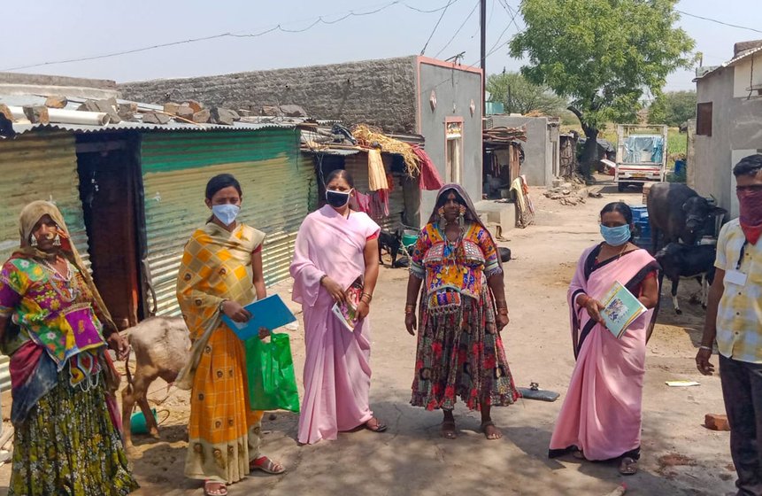 'Before April 6...I didn’t receive any no masks, gloves...' says Shakuntala Devi (standing third from left, and sitting with the green mask)