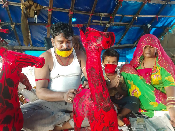 'No one in our community wants their children to continue doing this work', says Raju Bhat, with his wife Sanju and sons Rohit (left), and Deepak (right)