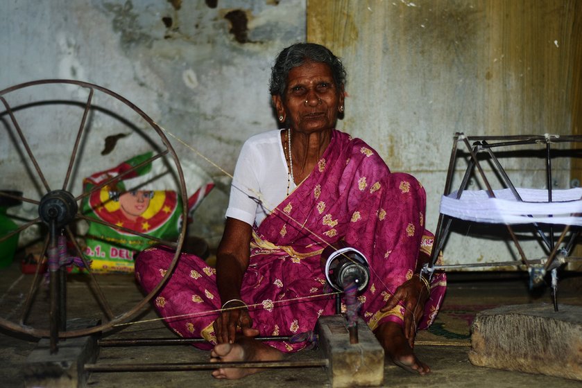 Shakuntala, 90 years old, spins the cotton thread using the charkha; she has been doing from the age of 20