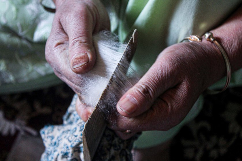 Left: Wool is pulled through a wooden comb to ensure the fibres are untangled and aligned.