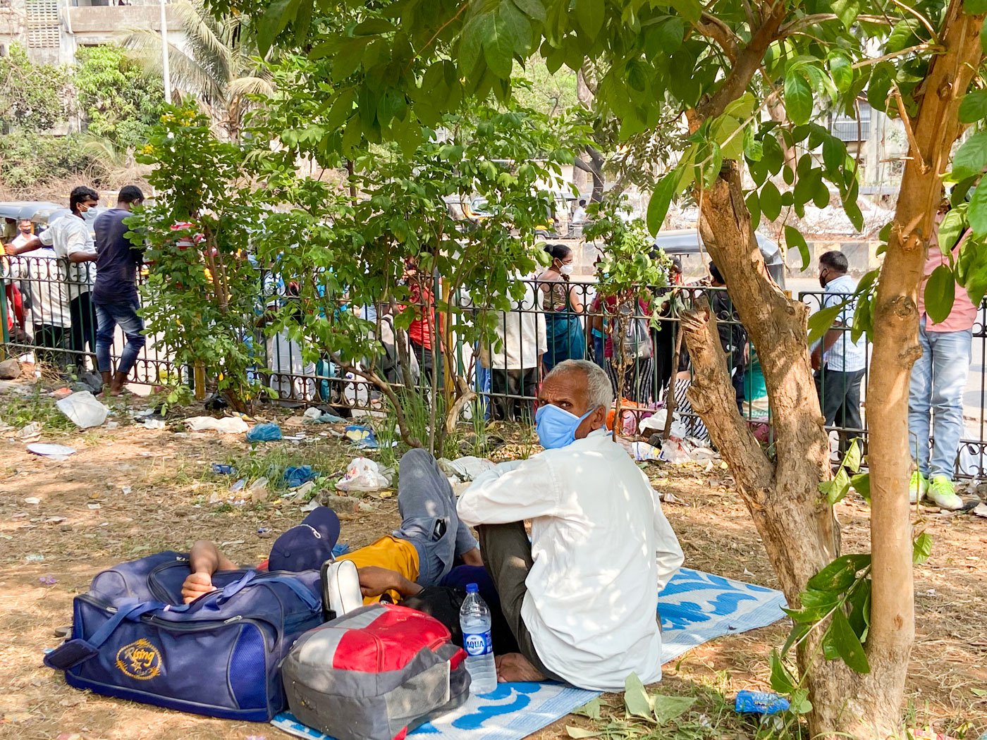 Migrant workers heading back home to the northern states waiting outside Lokmanya Tilak Terminus earlier this week