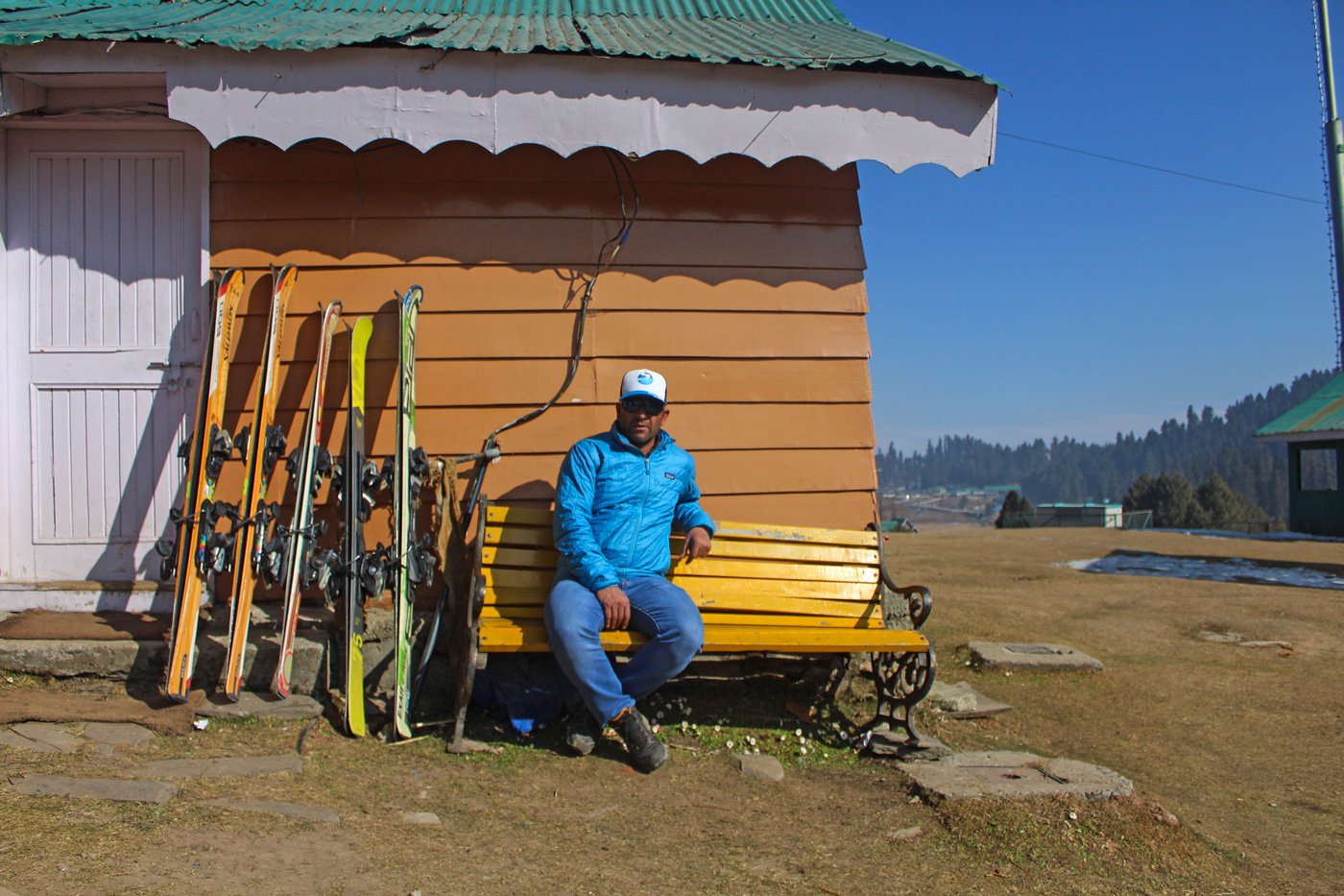 Javaid Reshi displays ski gear outside his hut in Gulmarg. Lack of snow in January has affected his livelihood