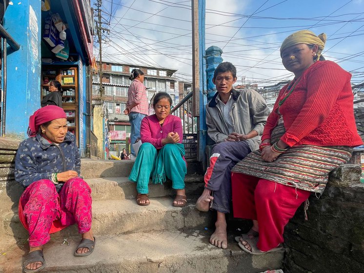 Left: Dhankumari Thami (blue jacket), Manbahadur Thami and Manmaya Thami (red sweater) rest in Chowk Bazaar between deliveries.