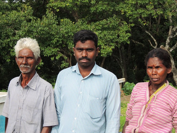 A young man standing with an old man and woman