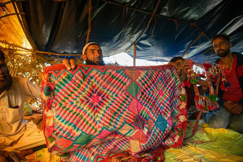 Munabbar Ali (left) and Maruf Ali (right) showing the handicrafts items they have made with Bakarwal wool