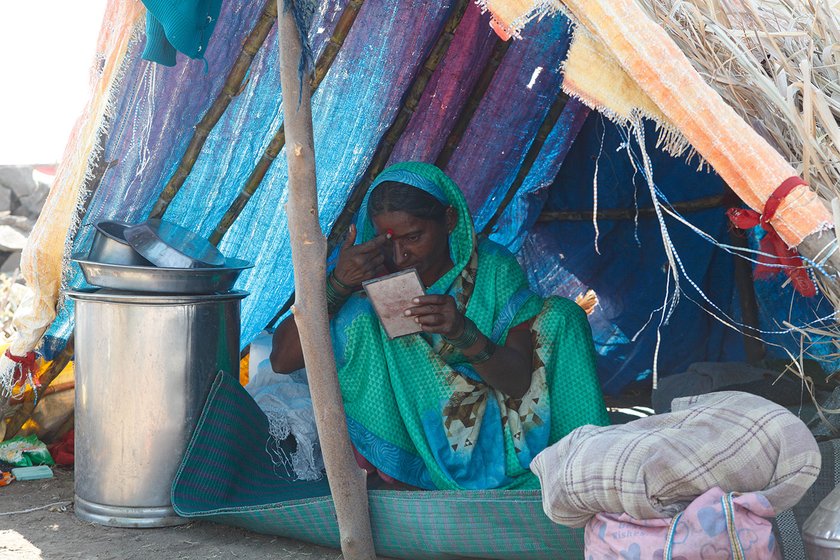 Lakshmi in her tent putting on a bindi/sindoor