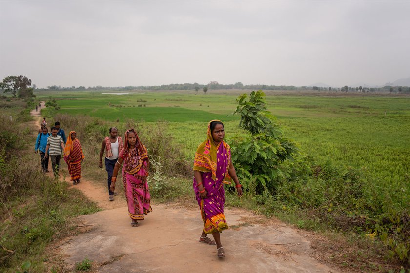 Parents and older siblings walking to pick up children from their new school in Chakua – a distance of 1.5 km from their homes in Puranamantira.