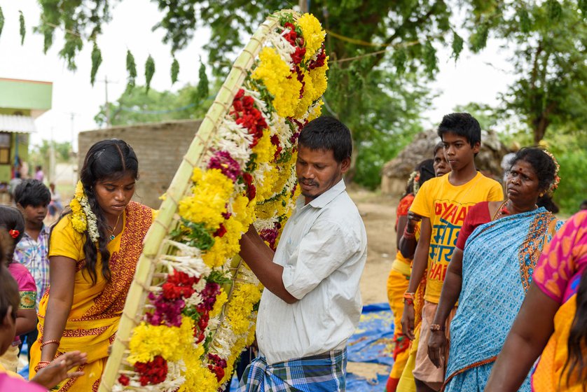 Right: G. Manigandan carries the completed thora or wreath