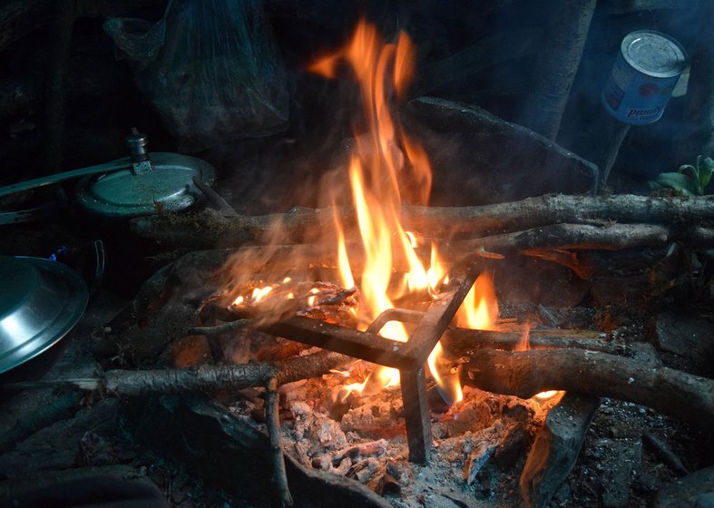 The villagers warm themselves from the bonfire after cooking is done in the evening. Firewood is collected from the forest below the alpine meadows