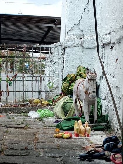 Right: A large wooden horse with a few clay horse figurines are offered by people in memory of revered saints who rode faithful horses