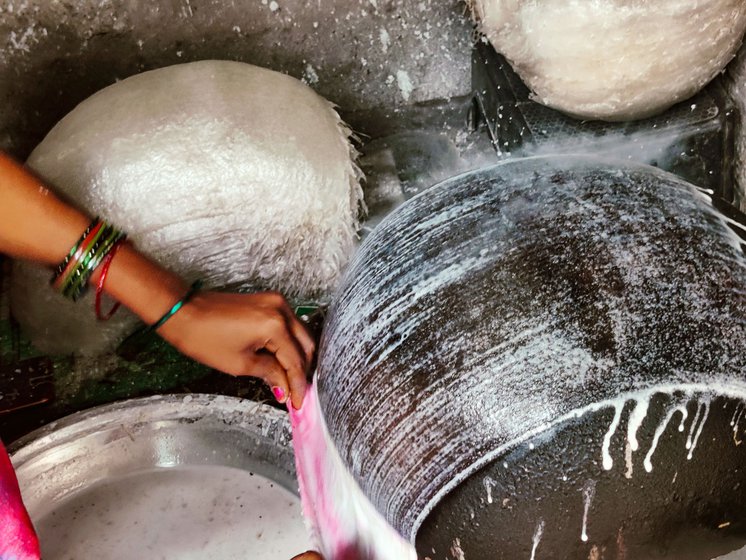 Veteran sweet maker, Vijaya has been making reku since 2019 and she says she always has to give it her full concentration. When she dips the cloth in the rice batter and lays it on the pot, a  film forms on the inverted pot (right)