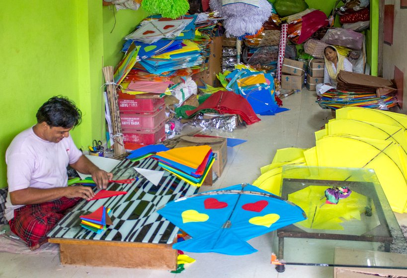 Raj Patangwala in Khambhat cuts the papers into shapes, to affix them to the kites