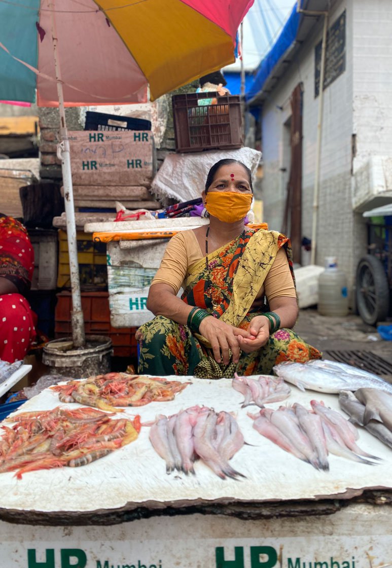 At Sassoon Dock, Sita Shelke (left) and other porters charge Rs. 40-50 to carry baskets to the fish market in Colaba. That day, Gayatri (right) had sent her basket on the two-wheeler of a neighbour