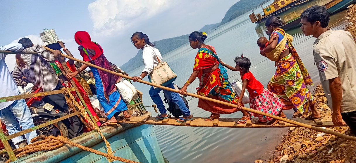 Kusama Naria (left), nearly nine months pregnant, walks the plank to the boat (right, in red saree) for Chitrakonda to get corrections made in her Aadhaar card