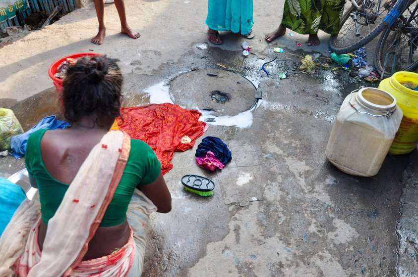 Left: Neetu's house is located alongside the railway track. Right: Women living in the colony have to wash and do other cleaning tasks on the unpaved street