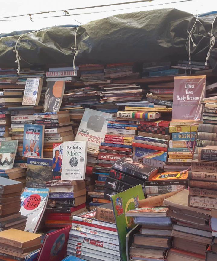 Right: Plastic sheeting protects hundreds of books at the stall from damage during the rains