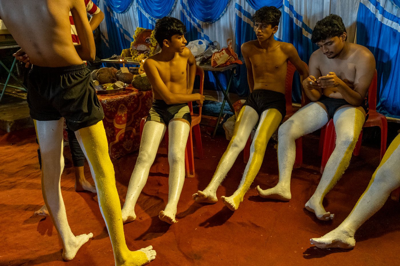 (Left to right) Shreyan Shetty , Ashlesh Raj and Karthik Acharya waiting for the first coat of paint to dry. The painting of bodies and faces requires hours of labour