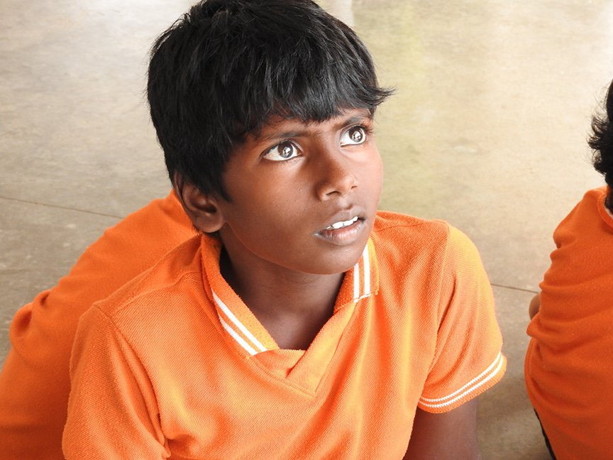A student listening to the teacher’s discourse on Dussehra.