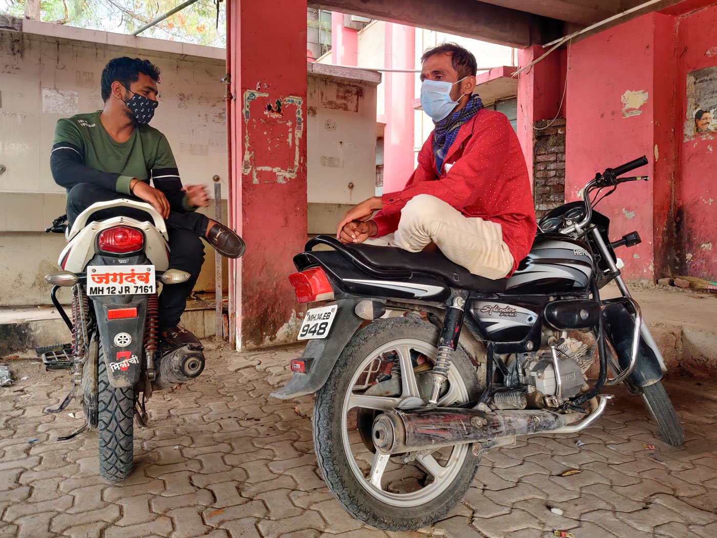 Nitin Sathe sitting on a motorbike outside the hospital while waiting to check on his parents in the hospital's Covid ward