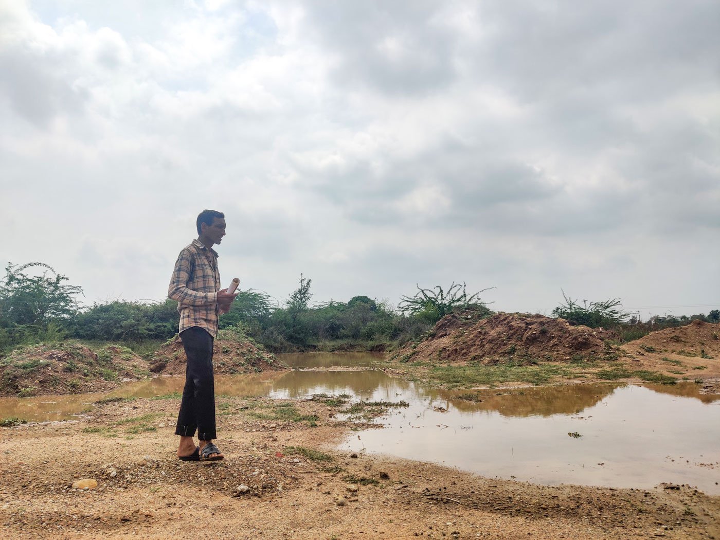 Walking through the puddles Chhaganbhai explains that the land is under water almost all the time