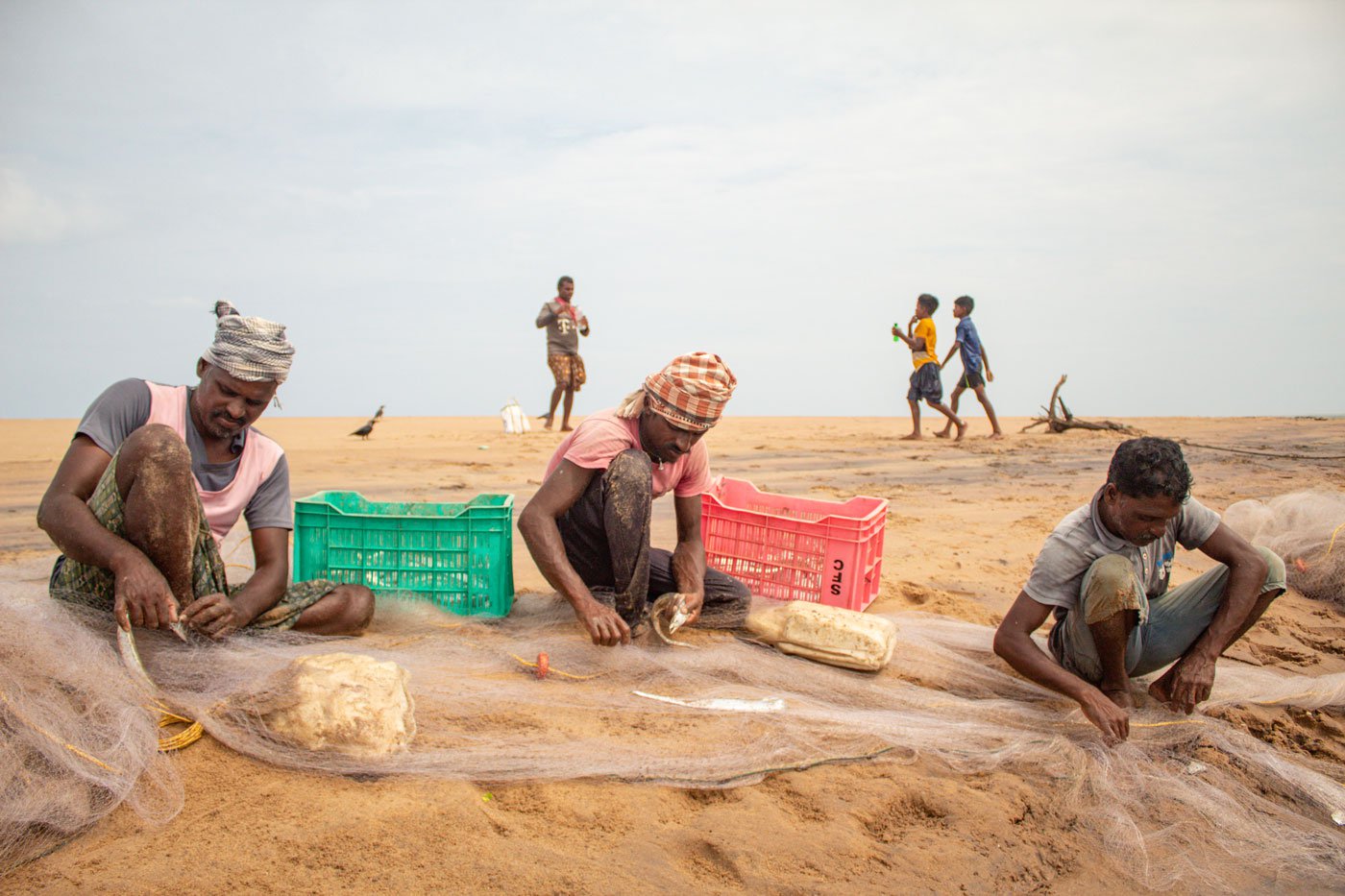 Fishermen in Podampeta cleaning their nets at the landing center.