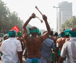 A farmer from Tamil Nadu brandishes two bones in the air as he marches towards Parliament Street.

