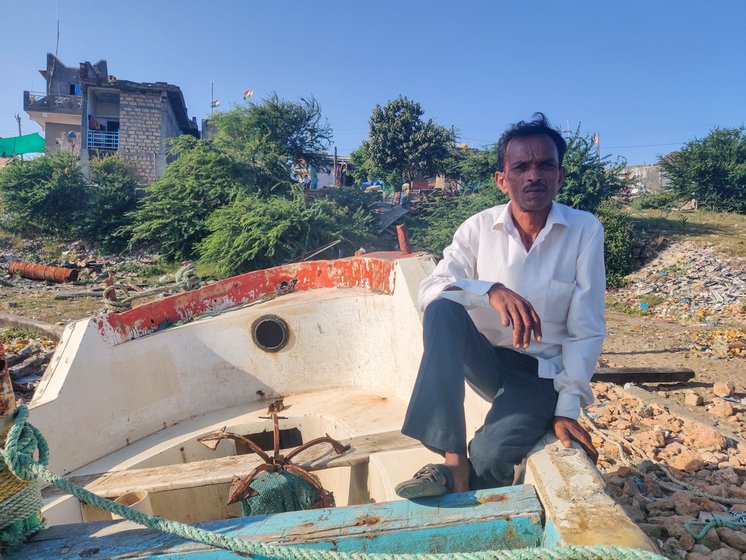 Jeevanbhai Shiyal on a boat parked on Jafrabad's shore where rows of fish are set to dry by the town's fishing community (right)