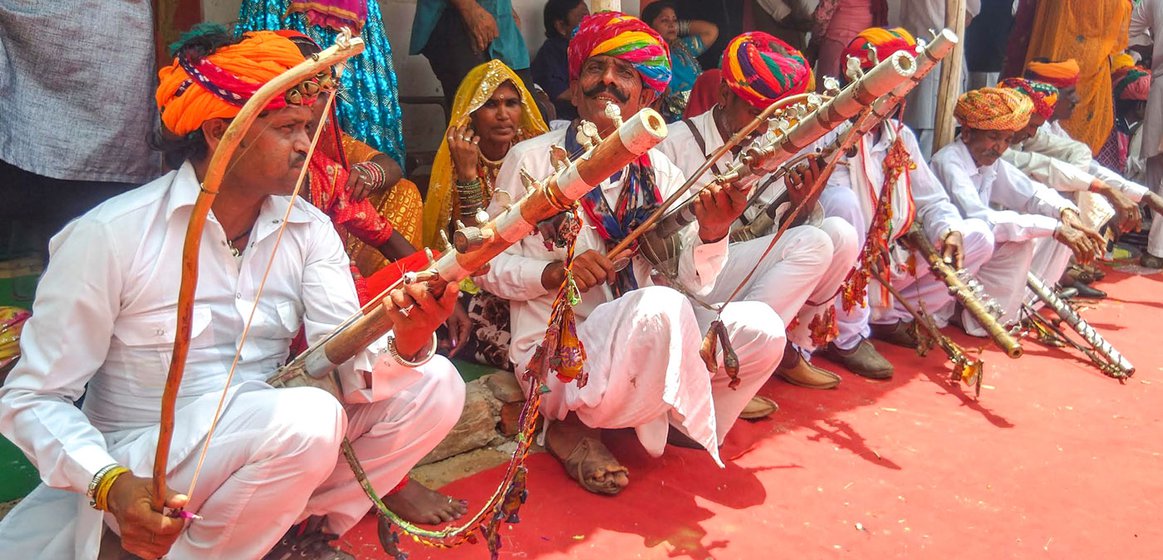 Left: Members of the Bhopas community playing Ravanhatta (stringed instrument) at the folk artists' mela