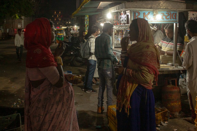 Left: The women have tea and snacks outside the railway station early next morning.