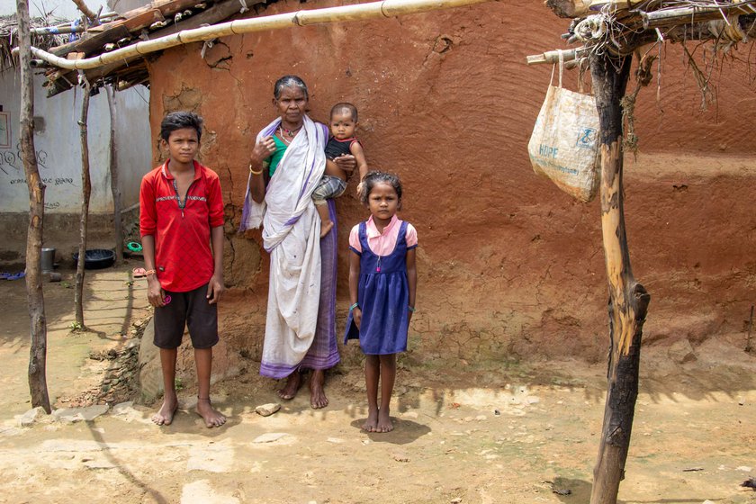 Left: Bute standing in front of her mud house along with her grandchildren and great grandchildren .