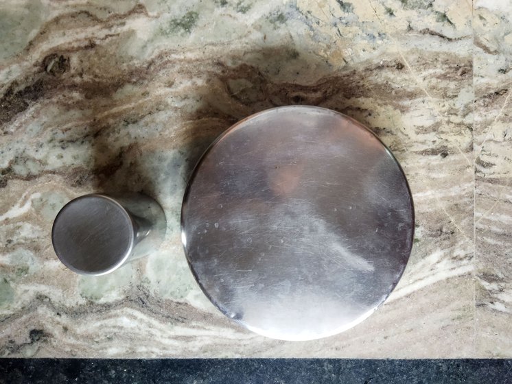 Utensils (left) and the washing area (centre) that are kept separate for menstruating females in Lata's home. Gau mutra in a bowl (right) used to to 'purify'