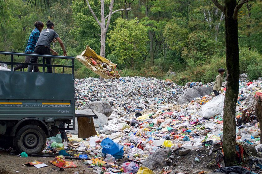 Left: Waste being unloaded at the dump site.