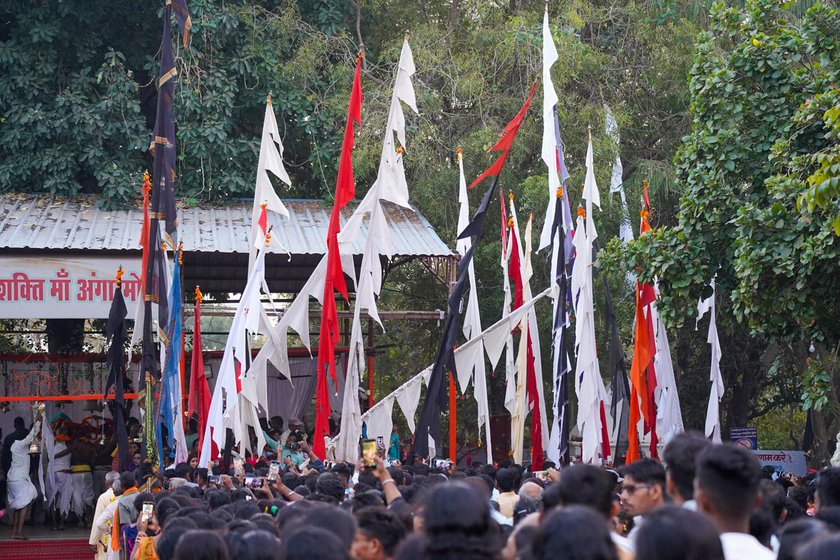 Right: Worshippers come to the madai with daangs or bamboo poles with flags symbolising deities