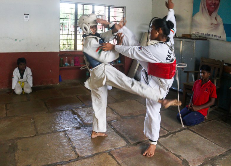 Sprinter and Taekwondo champion Aishwarya Birajdar (seated behind in the first photo) started experiencing heightened anxiety after the floods of 2021. She often skips her training sessions to help her family with chores on the farm and frequently makes do with one meal a day as the family struggles to make ends meet