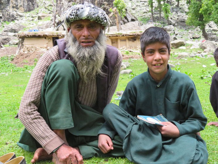 Right: Ajeeba Aman, the 50-year-old father of student Ejaz is happy his sons and other children are not missing school
