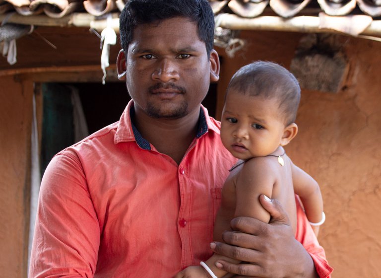 Right: Namani's eldest son Judhisthir holding his daughter Dhartiri
